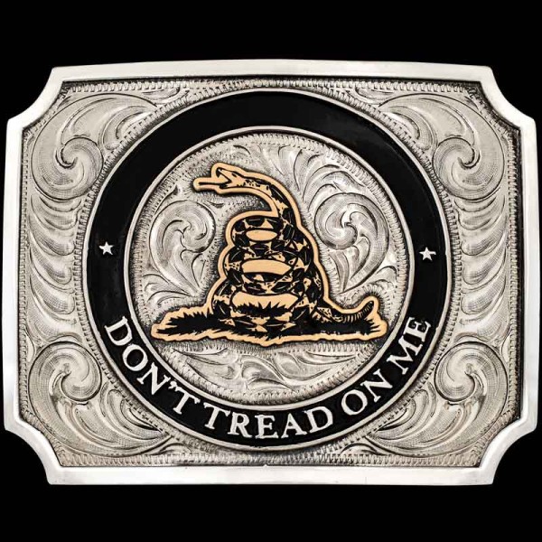"Stand strong, live free—don’t tread on me! Our Don't Tread on Me Belt Buckle is expertly crafted on a German Silver base featuring a striking hand-painted black enamel circle outline. The centerpiece displays our Jeweler’s Bronze timber rattlesnake,
